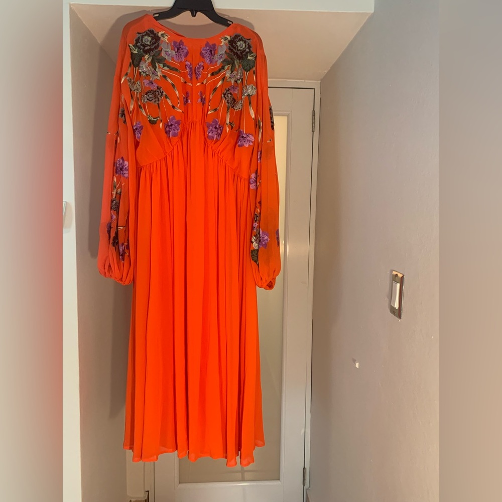Round neck Blouson Dress w/ floral embroidered sleeves & low back tie fastening.